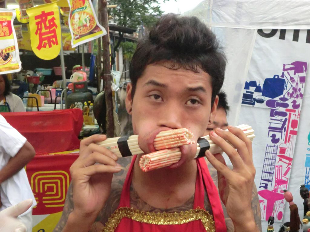 Face piercing in Phuket vegetarian festival